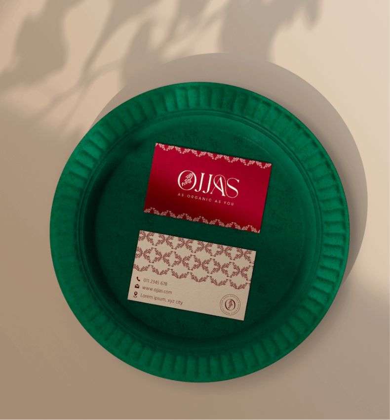 A rectangular business card with red and cream floral print, designed by Avval Digital Marketing Company for Ojjas brand