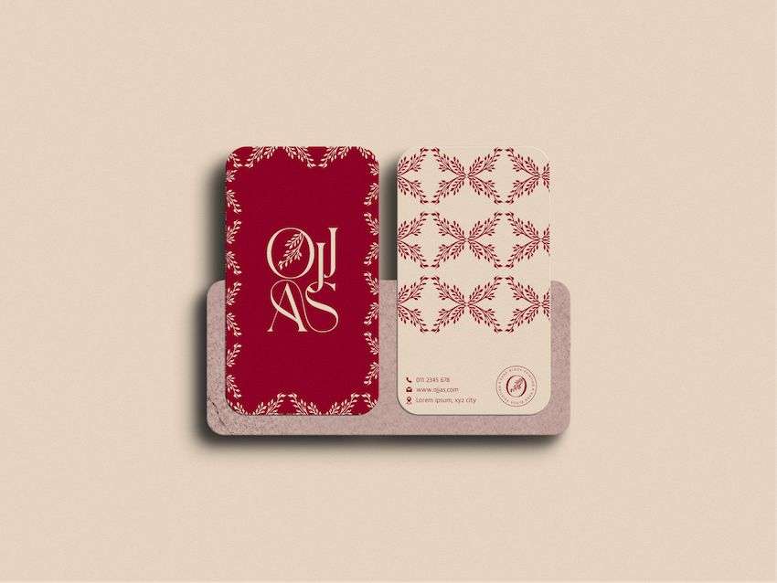 A rectangular business card with red and cream floral print, designed by Avval Digital Marketing Company for Ojjas brand