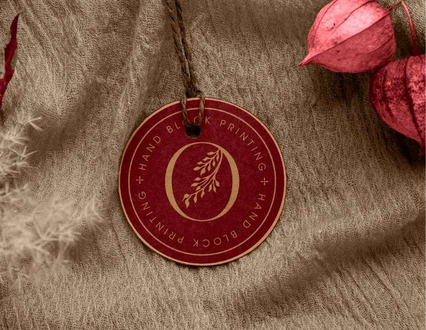 A rectangular swing tag with green and pink floral print, designed by Avval Digital Marketing Company for Ojjas brand